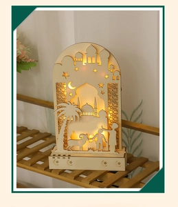 Macro shot of warm LED glow through laser-cut wooden moon lamp with mosque silhouette