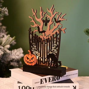 Detail of wooden Halloween silhouette lamp with bats and pumpkin in warm LED light