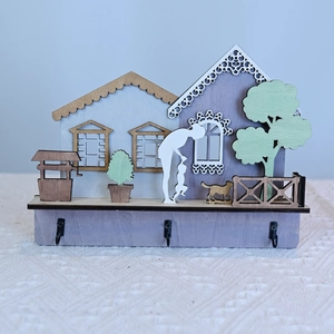 Handcrafted wooden house ornament with family silhouettes and three black metal wall hooks