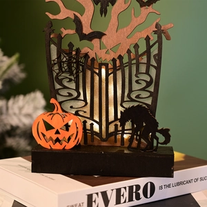 Macro shot of Halloween wooden light box featuring pumpkin and werewolf layered silhouette