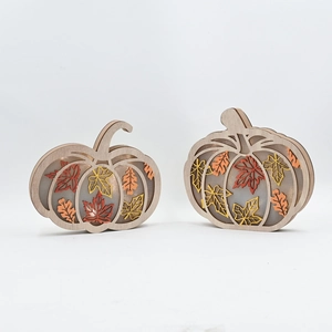 Detailed view of wooden pumpkin signs with maple leaves and warm harvest festival colors