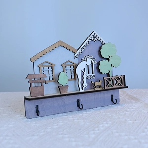 Detail view of wooden house wall decor with creative miniature scene and three black hooks