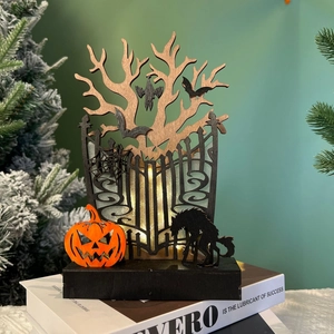 Detail of wooden Halloween LED light featuring spooky tree silhouettes and orange pumpkins