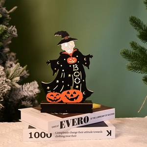 Detail of wooden Halloween skeleton figure with witch hat and small orange pumpkins
