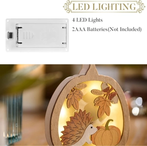 Détail de la lampe LED d'automne en bois montrant le boîtier à piles et les lumières LED