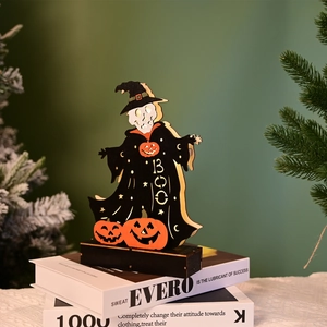 Macro shot of Halloween LED wooden decoration featuring skeleton witch and pumpkins