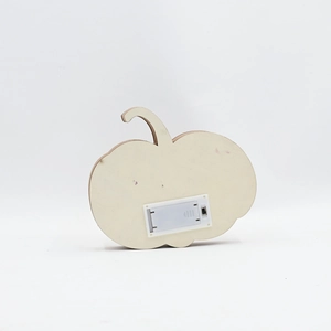 Rear view of wooden pumpkin LED light showing the battery compartment and toggle switch