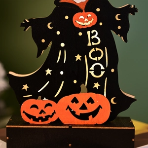 Close-up of Halloween wooden BOO ghost and pumpkin figurine with star patterns