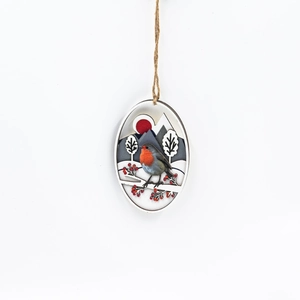 Macro detail of layered wooden bird ornament with robin and red berries on a branch