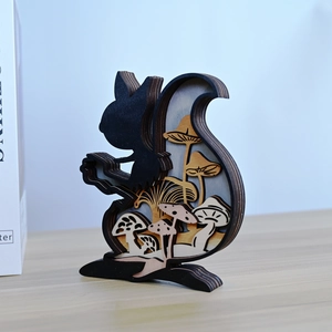 Detail of layered laser-cut wood squirrel figurine with forest mushroom carvings