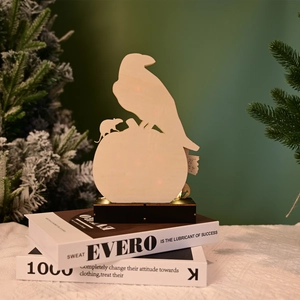 Macro detail of laser cut wooden crow silhouette with warm LED lighting on base
