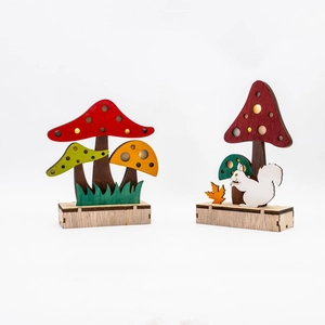 Detailed view of wooden mushroom ornaments with LED lights and autumn squirrel decor