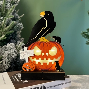 Close-up of wooden Halloween LED ornament with black crow and glowing BOO pumpkin