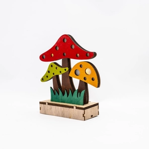 Macro detail of laser-cut wooden mushroom forest figurines with festive autumn colors