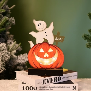 Detail of wooden Halloween ghost and BOO sign on a warm glowing LED pumpkin base