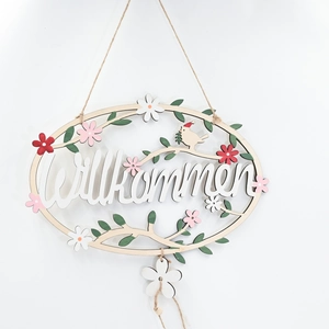 Wooden Willkommen welcome sign with floral vine design and rustic hanging rope