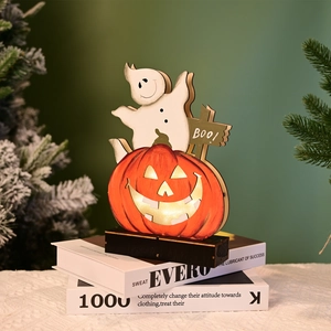 Detail of wooden Halloween pumpkin and ghost tabletop decor with BOO sign and LED lights