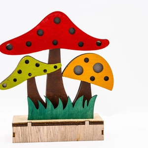 Detail view of the colorful wooden mushroom garden ornaments with slots and base