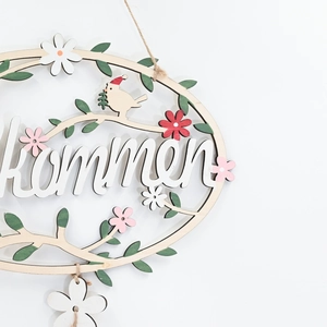 Floral wooden welcome wreath with painted bird and green leaves for home wall decor