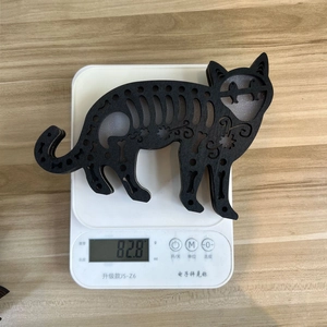 Weight measurement of wooden Halloween black cat decor with floral hollow carvings