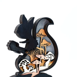 Detailed laser-cut wooden squirrel sculpture with multi-layer forest landscape design
