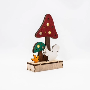 Detail of wooden mushroom forest lamp with autumn leaves and squirrel for desktop decor