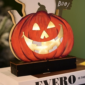 Detail of wooden Halloween pumpkin lamp with glowing LED light and Boo ghost sign