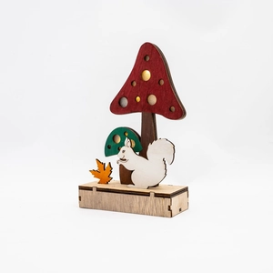 Close-up of wooden mushroom and squirrel table decor for autumn harvest festival