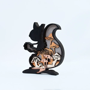 Detail view of multi-layer wood squirrel ornament with intricate mushroom forest carvings