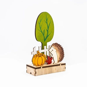 Dettaglio di scena del raccolto in legno con zucca, riccio e recinzione decorativa