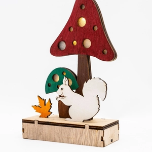 Detailed laser-cut wooden mushroom and squirrel forest scene ornament with autumn leaves