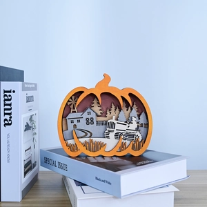 Detail of laser-cut wooden pumpkin featuring a 3D miniature rural farmhouse scene