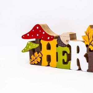 Detailed view of wood Thanksgiving letters with fall mushroom and acorn painted patterns