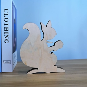 Detail of laser-cut wooden squirrel ornament with multi-layer silhouette design
