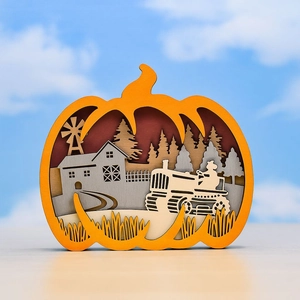 Detail of layered wood-carved pumpkin ornament featuring rural barn and tractor landscape