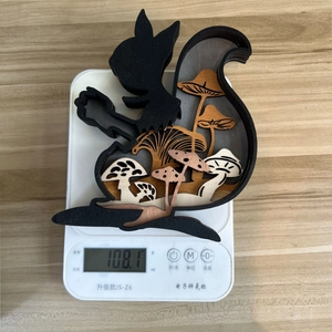 Close-up of a hollow wooden squirrel carving on a digital scale weighing 108.1 grams