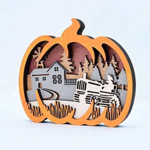 Detail of multi-layered wooden pumpkin ornament with 3D rural landscape and tractor carving