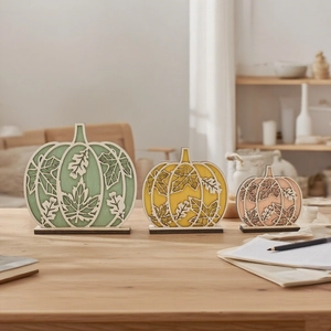 Three-piece pumpkin wood tabletop decor set with laser-cut leaf patterns for harvest festival