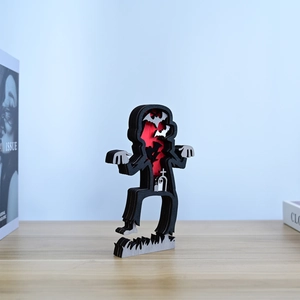 Detail of multi-layer laser cut wooden zombie statue with bats and graveyard scenery