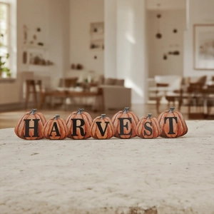 Detailed close-up of seven wooden pumpkin blocks spelling HARVEST for autumn decor