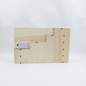 Detail of wooden advent calendar back with battery compartment and power switch
