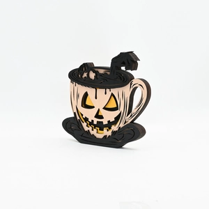 Detail of wooden Halloween pumpkin coffee cup decor with skeletal hand and 3D layered design