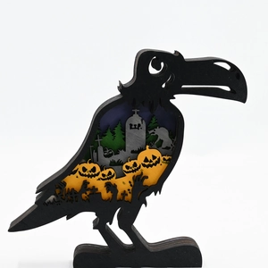 Detail of multi-layered wooden raven silhouette with carved pumpkins and cemetery scene