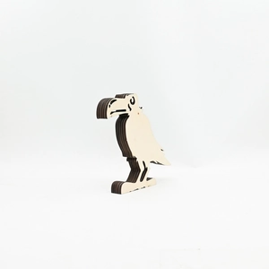 Detail of multi-layered laser cut wooden crow craft with natural wood grain texture