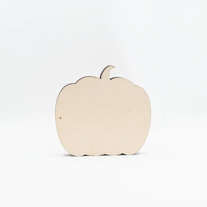 Detail of laser-cut pumpkin wooden slice with natural wood grain and dark burnt edges