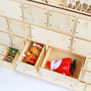 Detail of wooden advent calendar drawers with festive figurines and laser-cut numbers