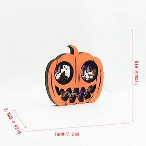 Detail showing 17cm height and 18cm width of the carved pumpkin Halloween ornament