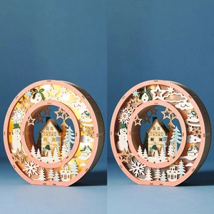 Illuminated laser-cut wooden Christmas ring with layered winter cabin and snowman scene