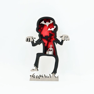 Detail of multi-layered wooden zombie cutout with bats, trees and RIP engraving for Halloween