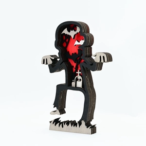 Close-up of laser-cut multilayer wooden Halloween zombie decor with RIP tombstone